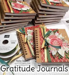 a pile of notebooks sitting on top of a table next to a cd case