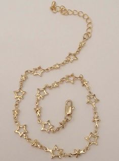 The Star Choker is a twinkling starlet! This shining star necklace is out if this world cute. It features a choker chain with stars interchanging from a solid to a cutout star pattern. Chain length: 11" + 2" extender chain Available in 24K gold or rhodium plating over steel Patent plating & sealant technology to ensure durability and long lasting wear Made in Los Angeles, CA | Nickel & Lead Free Star Choker, Jewelry Accessories Ideas, Dope Jewelry, Classy Jewelry, Funky Jewelry, Jewelry Lookbook, Star Jewelry, Shining Star, Star Pattern