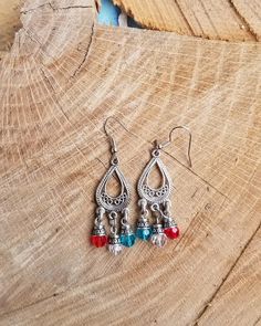 Antiqued Silvertone metal chandelier teardrop earrings in a smaller size. Red, blue and clear faceted glass beads attached. Chandelier base is finished on both sides. All dangling from a silvertone metal French hook earwires that can be changed to a leverback style at your request with no additional cost. Beaded Metal Teardrop Chandelier Earrings, Red Teardrop Earrings With Dangling Beads, Silver Chandelier Earrings With Faceted Beads, Bohemian Dangle Teardrop Earrings With Faceted Beads, Silver Teardrop Earrings With Dangling Beads, Metal Teardrop Earrings With Dangling Beads, Silver Beaded Teardrop Chandelier Earrings, Silver Teardrop Beaded Earrings With Faceted Beads, Silver Teardrop Crystal Earrings With Dangling Beads