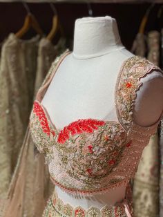 Light pink intricate with fully sequence, studs motifs thread embroidery and crystal stone work lehenga embellished with beautiful outline in red sequins paired with sweetheart neckline blouse and net dupatta. Fabric Net Custom designed according to client measurements and color preference. Production and delivery time is 90days! Hand Embellished Bollywood Blouse Piece For Reception, Bollywood Style Hand Embellished Blouse Piece For Reception, Hand Embellished Semi-stitched Choli For Reception, Semi-stitched Hand Embellished Choli For Reception, Bollywood Style Embellished Choli For Reception, Embellished Party Wear Blouse For Wedding, Embellished Blouse Piece For Wedding Party, Wedding Party Wear Blouse With Intricate Embroidery, Traditional Festive Lehenga With Fitted Bodice