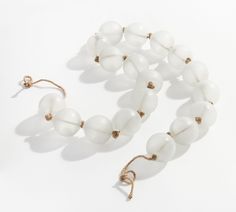 a white beaded necklace on a string