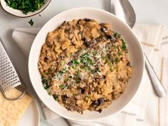 a bowl of pasta with mushrooms and parmesan cheese