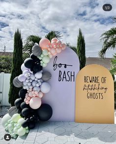 balloon arch with black, white and pink balloons in front of the sign saying beware of ghost