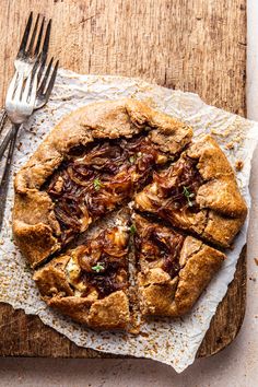 a pie on a wooden cutting board with a fork