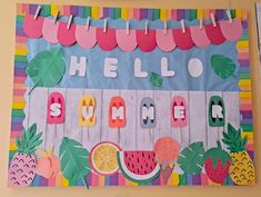 a bulletin board with the words hello summer written on it and fruit cutouts hanging from clothes pins