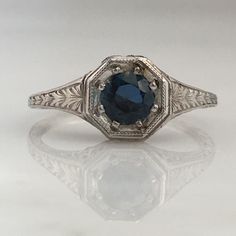 Details: Stunning Art Deco Period platinum and sapphire ring--would make a lovely wedding ring! The center stone is estimated .40 carats, and measures 4.9mm round. The filigree is beautiful on this ring, and is in lovely shape. This is a stunning ring--you will not be disappointed! Please ask all necessary questions prior to placing an order. Measurements: The size is 5 1/2 US and can be sized for a fee. Condition: The overall all condition of this ring is very good. Classic Sapphire Halo Ring, Formal Sapphire Diamond Ring In Platinum, Classic Sapphire Birthstone Ring, Timeless Sapphire Promise Ring With Round Band, Timeless Sapphire Promise Ring, Formal Sapphire Diamond Cut Ring, Formal Sapphire-colored Diamond Ring, Classic Formal Diamond Ring With Lab-created Sapphire, Timeless Sapphire Promise Ring With Prong Setting