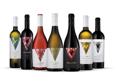 six bottles of wine are lined up in a row on a white background, with the label design printed onto it