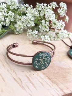 G R E E NA N D W H I T EThis stunning antique copper bangle contains a beautiful pressed real Queen Anne's Lace flower, set against a cool green resin background.It's part of a new range of jewellery,  all handmade in the UK.   These unique pieces make beautiful, unique gifts. Perfect for Mother's Day, Birthdays and Anniversaries, or just to treat yourself!  They would also make great bridesmaids gifts or be stunning as bridal jewellery.  Available in an on trend range of colours, they will comp Adjustable Copper Flower Jewelry, Nature-inspired Cuff Bangle Bracelet As Gift, Nature-inspired Cuff Bangle Bracelet For Gifting, Nature-inspired Bangle Cuff Bracelet As Gift, Rose Gold Copper Bangle As Gift, Adjustable Nature-inspired Bangle As A Gift, Handmade Nature-inspired Bangle As Gift, Green Nickel-free Cuff Bracelet As Gift, Green Cuff Bracelet Gift