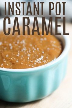 a blue bowl filled with caramel sauce on top of a wooden table