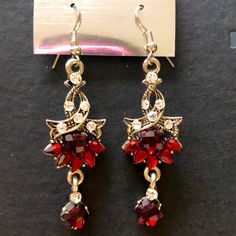 Brand New Earrings In Color Red With Diamonds Around It. You Can Wear These Earrings With A Simple Outfit For A Fancy Outfit It Would Look Good In Both. Red Metal Drop Earrings, Party Ruby Earrings In Silver, Party Ruby Silver Earrings, Red Crystal Metal Earrings For Parties, Red Crystal Metal Party Earrings, Elegant Silver Earrings For Christmas, Red Metal Crystal Party Earrings, Elegant Silver Christmas Earrings, Red Metal Earrings For Party