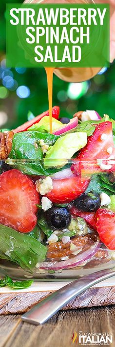 a salad with strawberries and spinach on it