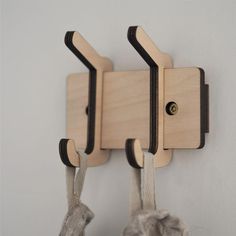 two wooden hooks are attached to the wall