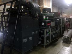 many boxes are stacked on top of each other in an industrial warehouse with light shining through the windows