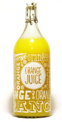 orange juice in a glass bottle on a white background