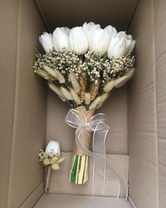 a bouquet of white flowers in a box