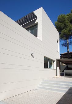 a white building with stairs leading up to it