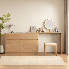 a bedroom with a dresser, mirror and stool next to a plant on the floor