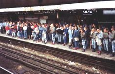 a group of people waiting on a train platform