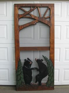 two bears are playing with each other in front of a garage door