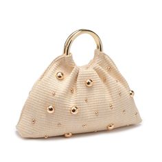 A perfect blend of chic style and natural vibes. Its open design, adorned with stud embellishments on woven straw, exudes an effortless charm. Carry it elegantly with the round top handle, and find convenience in the fabric-lined interior with a handy zip pocket. Item Type: Evening Bag Material: Straw Closure: Open Exterior Details: Woven Design, Stud Embellishments, Round Top Handle, Gold Hardware Interior Details: Fabric Lined, 1 Zip Pocket 14.77” L x 2.76” W x 6.89” H Luxury Chic Straw Bag, Luxury Cream Bags For Summer, Luxury Formal Bags With Interwoven Design, Luxury Gold Evening Bag With Round Handle, Luxury Classic Shoulder Bag With Pebbled Texture, Luxury Summer Bags With Gold-tone Hardware, Luxury Handwoven Bags With Round Handle, Luxury Summer Evening Straw Bag, Luxury Evening Bag With Braided Handles