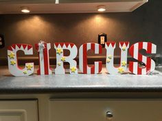 the word circus is made out of wood letters on a countertop in a kitchen