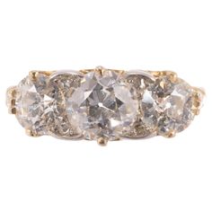 A beautiful and increasingly rare all original antique three-stone diamond ring. The yellow gold ring is fashioned in the "English Carved" motif and features three diamonds approximately H color and VS clarity. The center Old European Cut diamond measures 1.14 carats with matching Old European Cut diamonds weighing 0.58 carats each on either side. Altogether a very special and rare diamond ring in excellent condition. Circa 1890 Antique Oval Three Stone Diamond Ring, Antique Three Stone Diamond Ring In Diamond White, Rare Diamond Rings, Rare Diamond, Contemporary Engagement Rings, Three Stone Diamond Ring, Carved Ring, 3 Stone Rings, Three Stone Diamond