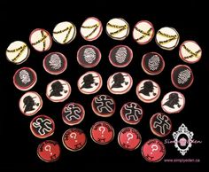 an assortment of decorated cookies with black and red designs