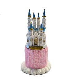 a pink and white cake with a castle on top