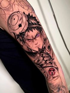 a man's arm with an anime character tattoo on it, and his eyes are closed