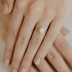 a woman's hand with a ring on it