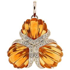 A fan motif is formed by three citrines carved into tapering ridges. They meet at their narrowest points, where the lower edge of each gem is adorned with round brilliant cut diamonds set in 18k white gold. The pendant measures 1.57 inches (length) by 0.39 inches (depth). Art Deco Pendant Necklace, Art Nouveau Pendant, Lion Pendant, Carved Pendant, Citrine Jewelry, Necklaces Pendant, Citrine Pendant, Art Deco Pendant, Gold Designs