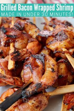 grilled bacon wrapped shrimp on skewers with text overlay that reads grilled bacon wrapped shrimp made in under 30 minutes