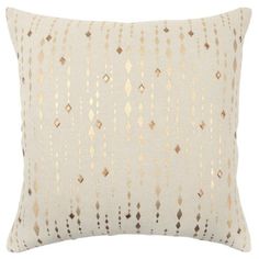 a white and gold pillow with fringes on the front, in an embroidered pattern