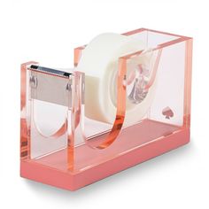 a roll of toilet paper is in a clear holder with pink tape on the side