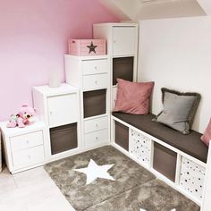 a child's bedroom with pink walls, white furniture and stars on the rug