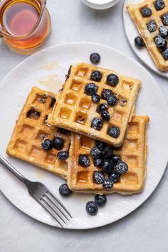 waffles with blueberries and syrup on a white plate