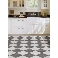 a black and white checkered floor in a kitchen with cabinets, counter tops, and sink