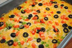 a casserole dish with olives, peppers, and onions in it is ready to be eaten