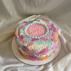 a colorful cake with the words george queen on it