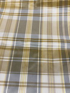 a plaid fabric with yellow and grey stripes