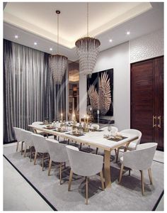 an elegant dining room with chandelier and large table set for eight people in white chairs