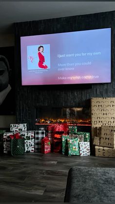 presents sitting on the floor in front of a flat screen tv