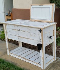 an old wooden cooler sitting on top of a sidewalk