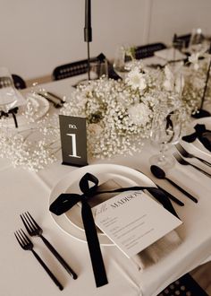 the table is set with black and white place settings