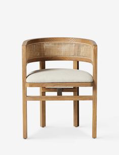 a wooden chair with a white cushion on it