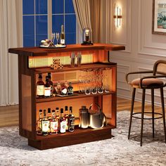 a bar with liquor bottles and glasses on the shelves in front of a large window