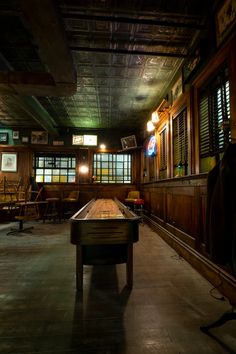 an empty room with a pool table in it