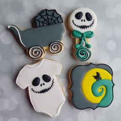 three decorated cookies in the shape of jack skellings and a baby stroller