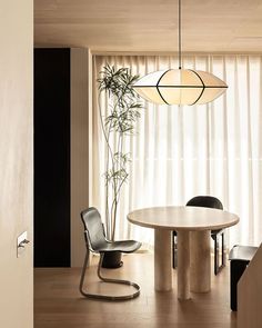 a dining room with a round table and chairs