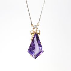 Gorgeous modern circa 2000's estate 18k rosy yellow & white gold genuine amethyst & diamond necklace! This stunning piece features a fancy cut amethyst gemstone, which is securely prong set. Above the purple gem is a bow motif with a bezel set diamond. The 15 inch chain is so unique with alternating yellow & white gold. A fabulous & high quality piece of fine modern jewelry, featuring February's birthstone! *Sale - price reduced from $975 USD to $965 USD.  ERA - Circa 2000's - Estate  METAL / MATERIAL - 18k rosy yellow & white gold, genuine amethyst, genuine single cut diamond (.06 ct) MARKINGS / HISTORY - N/A  CONDITION - Good condition. Gold metal has been professionally polished & cleaned. Genuine amethyst & diamonds are secure. Amazing genuine gemstone necklace!  SIZE / MEASUREMENTS - Luxury Yellow Gold Amethyst Necklace, Pear-shaped Amethyst Necklace For Gift, Multi-stone Amethyst Pendant Jewelry, Gem Pendant, High-end Faceted Amethyst Necklaces, Purple Multi-stone Pendant Gemstones, Purple Gems, Art Deco Pendant, Bezel Set Diamond